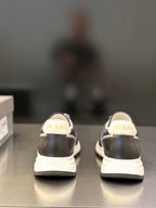 Prada unisex sneakers, rear view with PRADA logo on heel, dark navy