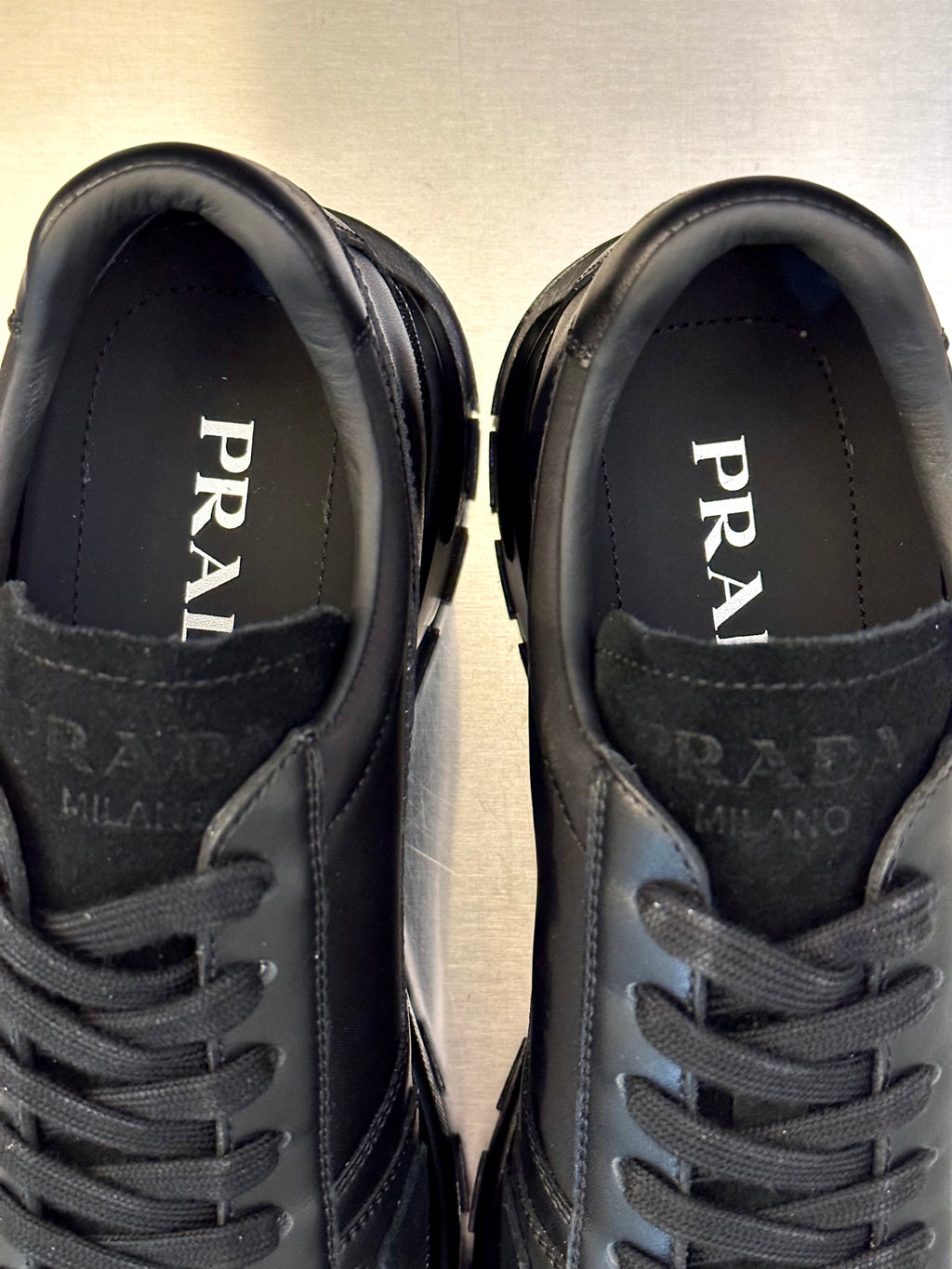 Prada unisex sneakers, close-up of tongue lining with PRADA and MILANO text