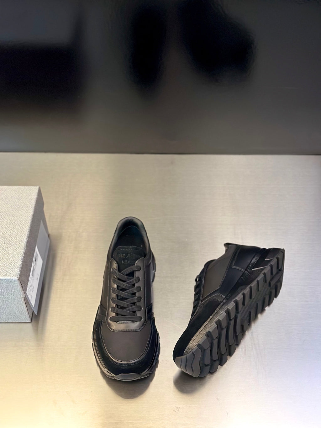 Prada unisex lace-up sneakers, dark gray; side view with textured rubber sole tread