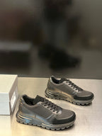 Prada unisex lace-up sneakers, dark gray; angled side view showing textured outsole