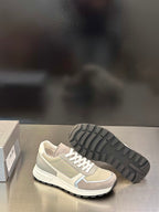 Prada unisex sneakers showing treaded rubber outsole and white lace-up upper