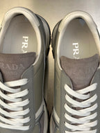 Close-up of Prada unisex sneaker tongues and side panels with white laces