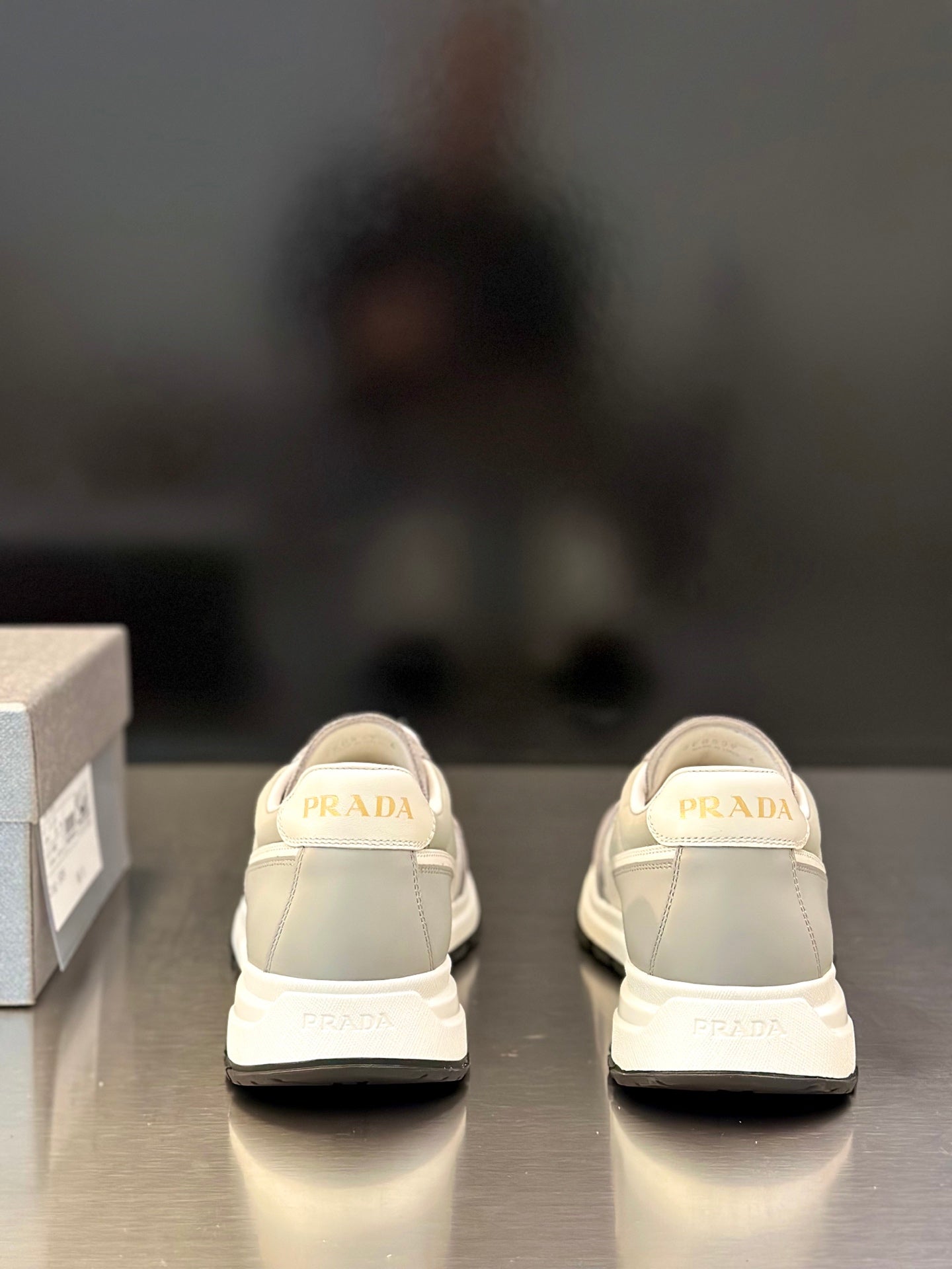 Prada unisex sneakers from rear view with PRADA logo on heel tabs