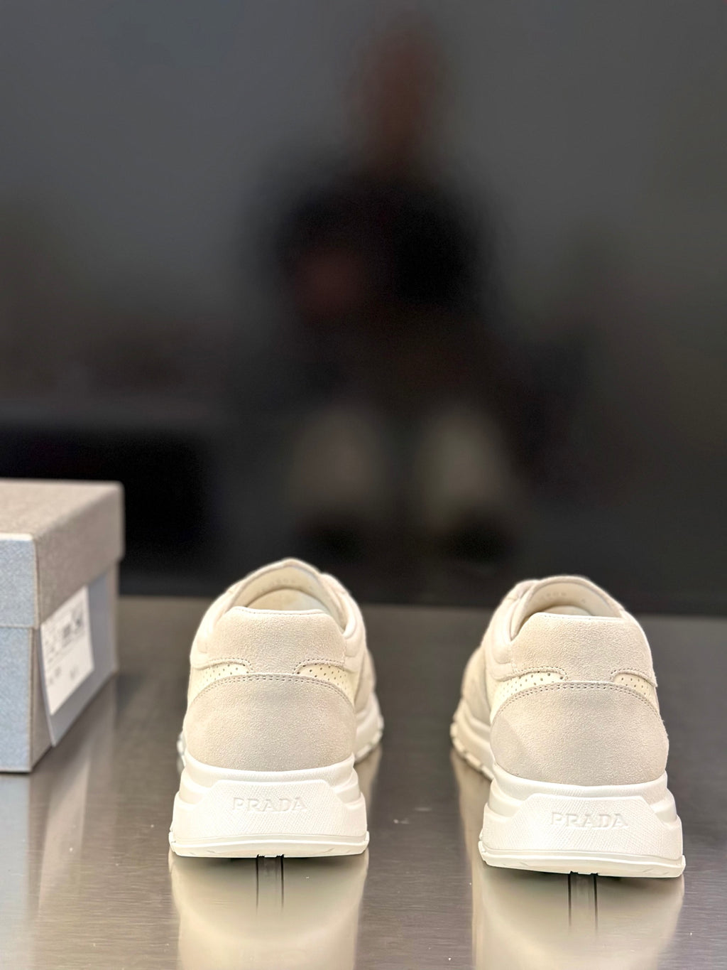 Prada unisex sneakers showing back heel tabs and PRADA logo on heel
