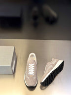 Prada unisex sneakers, light gray front and side view, white laces, dark tread outsole