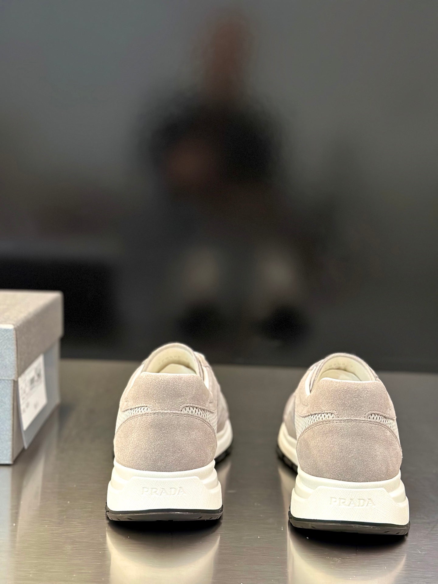 Prada unisex sneakers heel view, light gray suede upper, PRADA logo on back