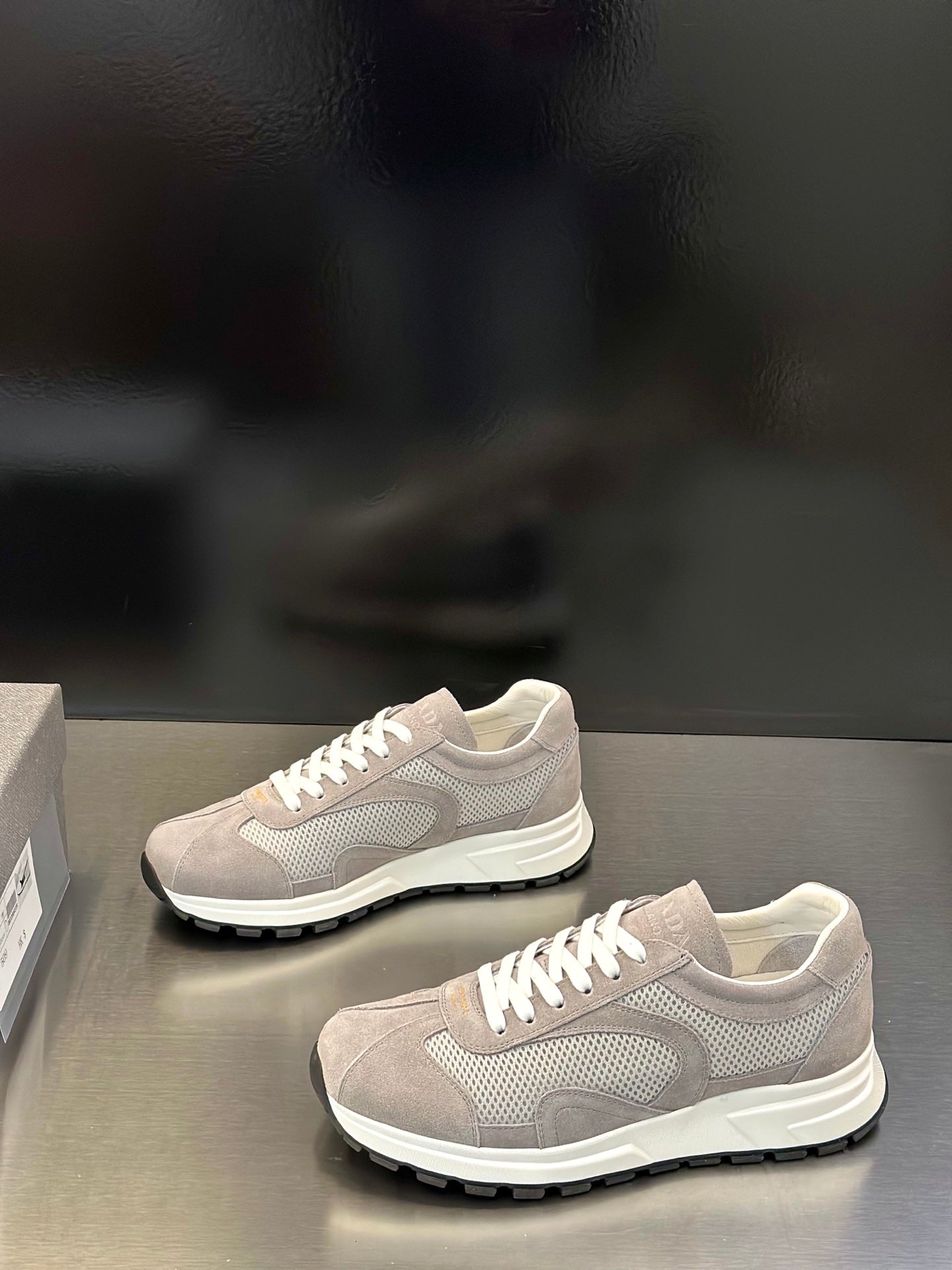 Prada unisex running-style sneakers, light gray mesh upper, white laces, chunky sole