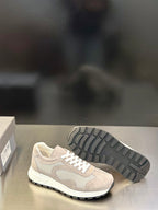 Prada unisex sneakers, light gray upper and treaded outsole, white lace-up front