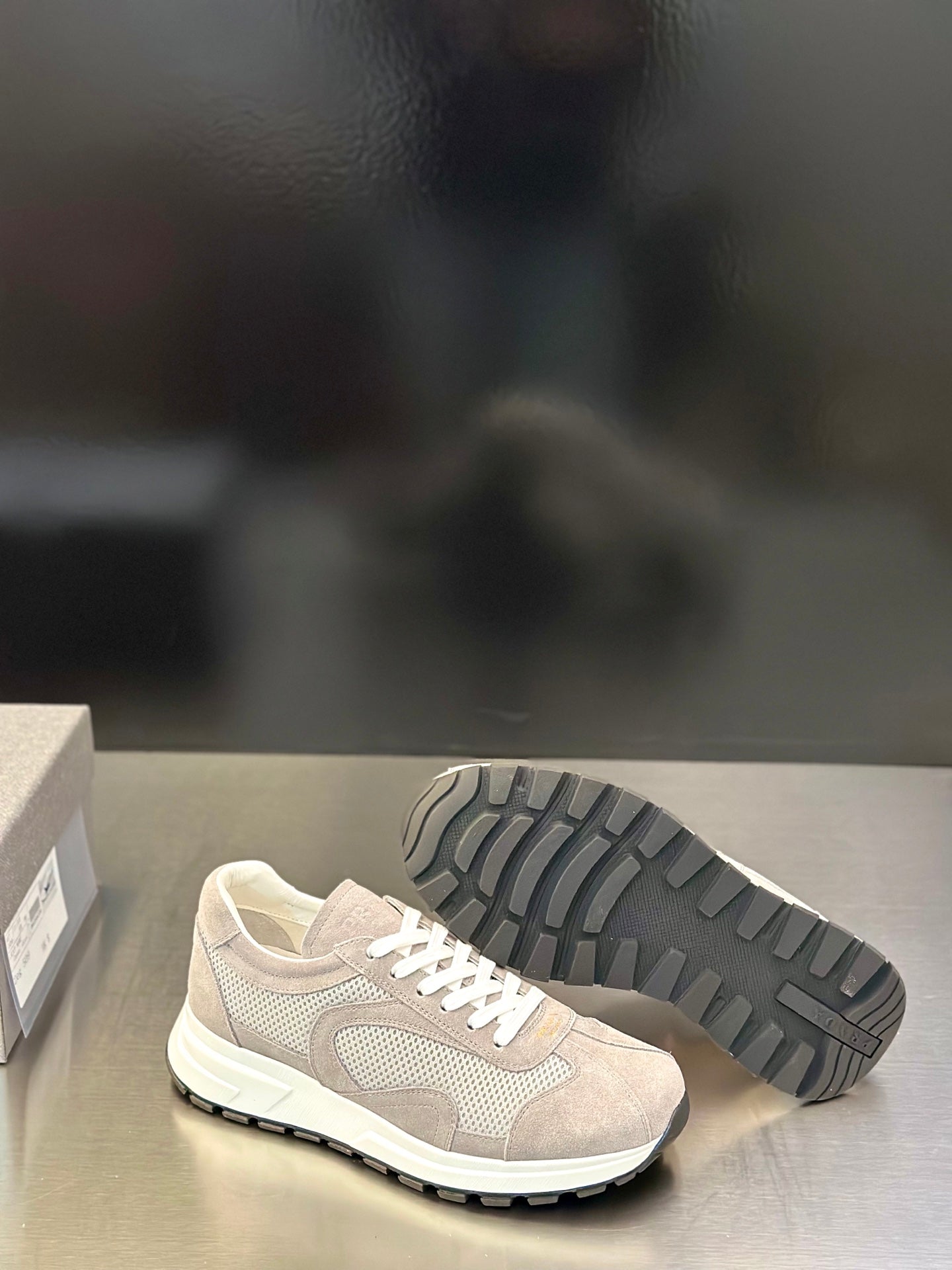 Prada unisex sneakers, light gray upper and treaded outsole, white lace-up front