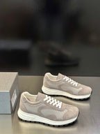 Prada unisex sneakers with light gray upper, white laces, thick black-rim sole