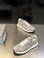 Prada unisex sneakers, light gray upper with white lace-up front, street-style profile