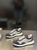 Prada unisex sneakers side view, navy suede upper with white laces and thick sole
