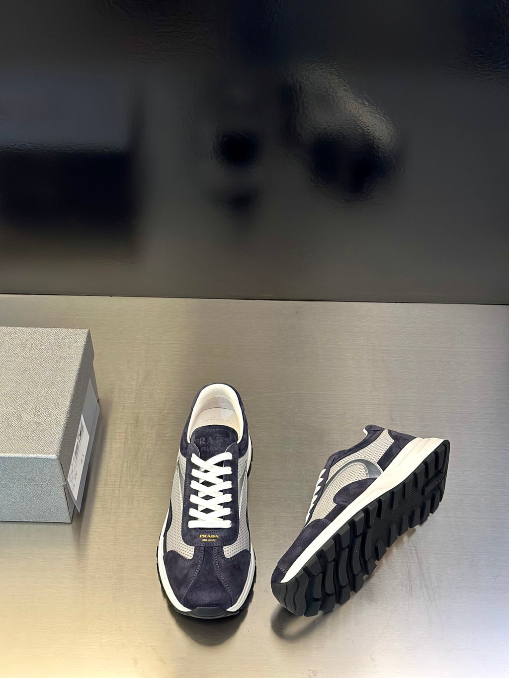 Prada unisex sneakers pair view, navy upper with white midsole and outsole