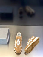 Tan suede sneakers with white panels and lace-up front, side and sole view