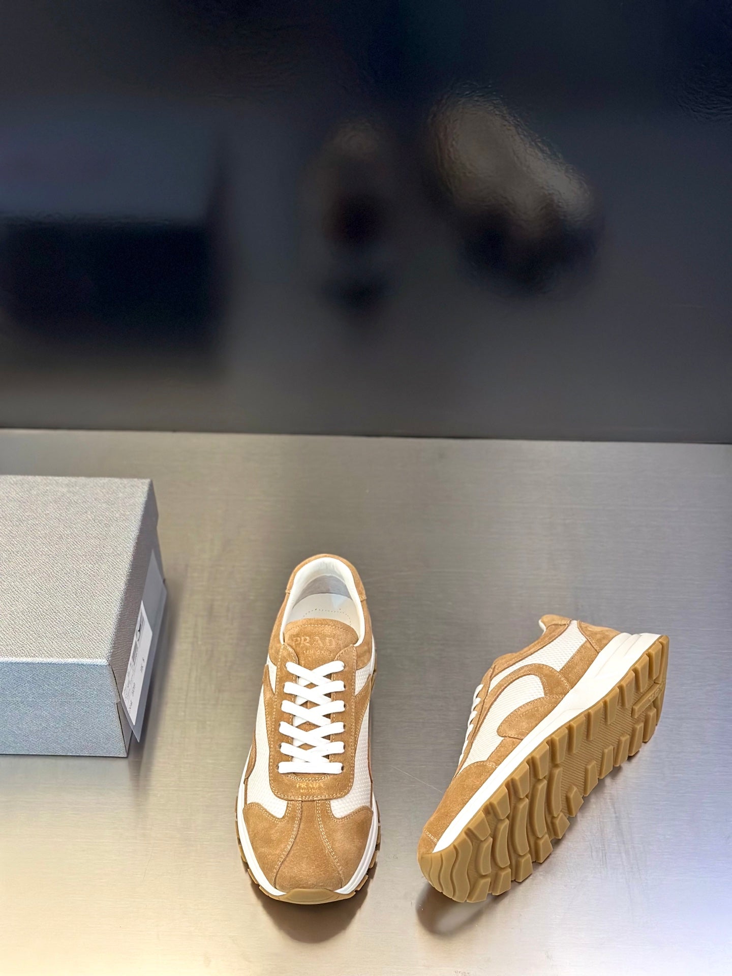 Tan suede sneakers with white panels and lace-up front, side and sole view