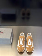 Tan suede sneakers with white panels, lace-up front, chunky rubber sole