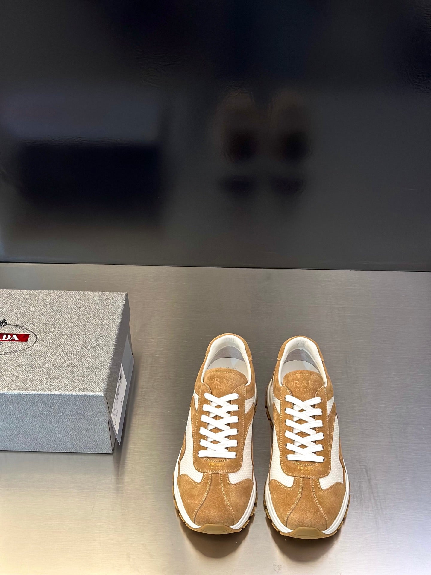 Tan suede sneakers with white panels, lace-up front, chunky rubber sole