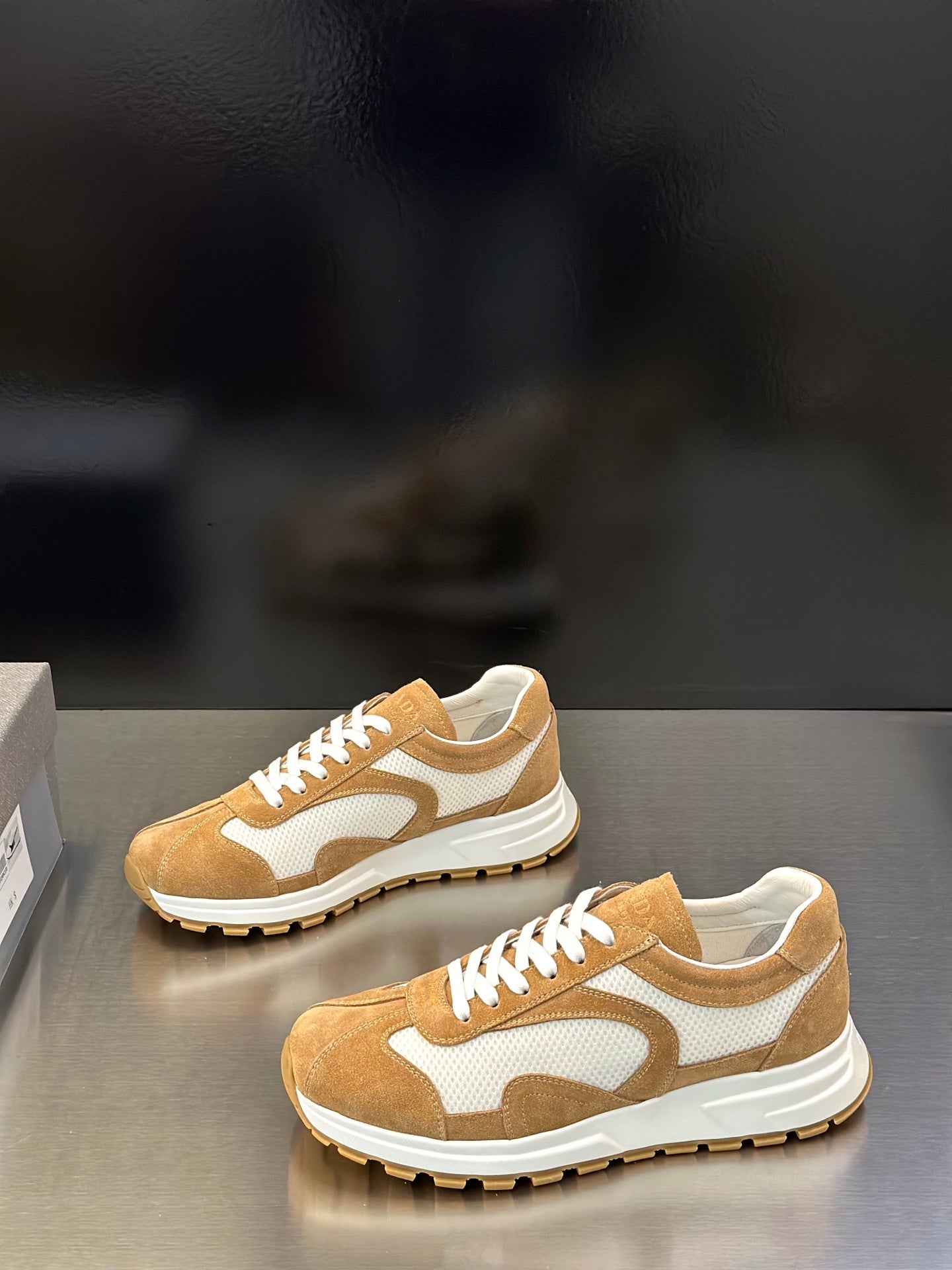 Tan and white lace-up sneakers with white midsoles and treaded rubber outsole