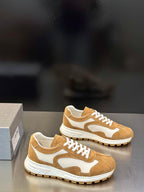 Tan and white lace-up sneakers with suede upper and rubber tread sole