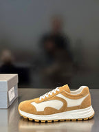 Tan suede low-top sneakers with white panel detailing and lace-up front