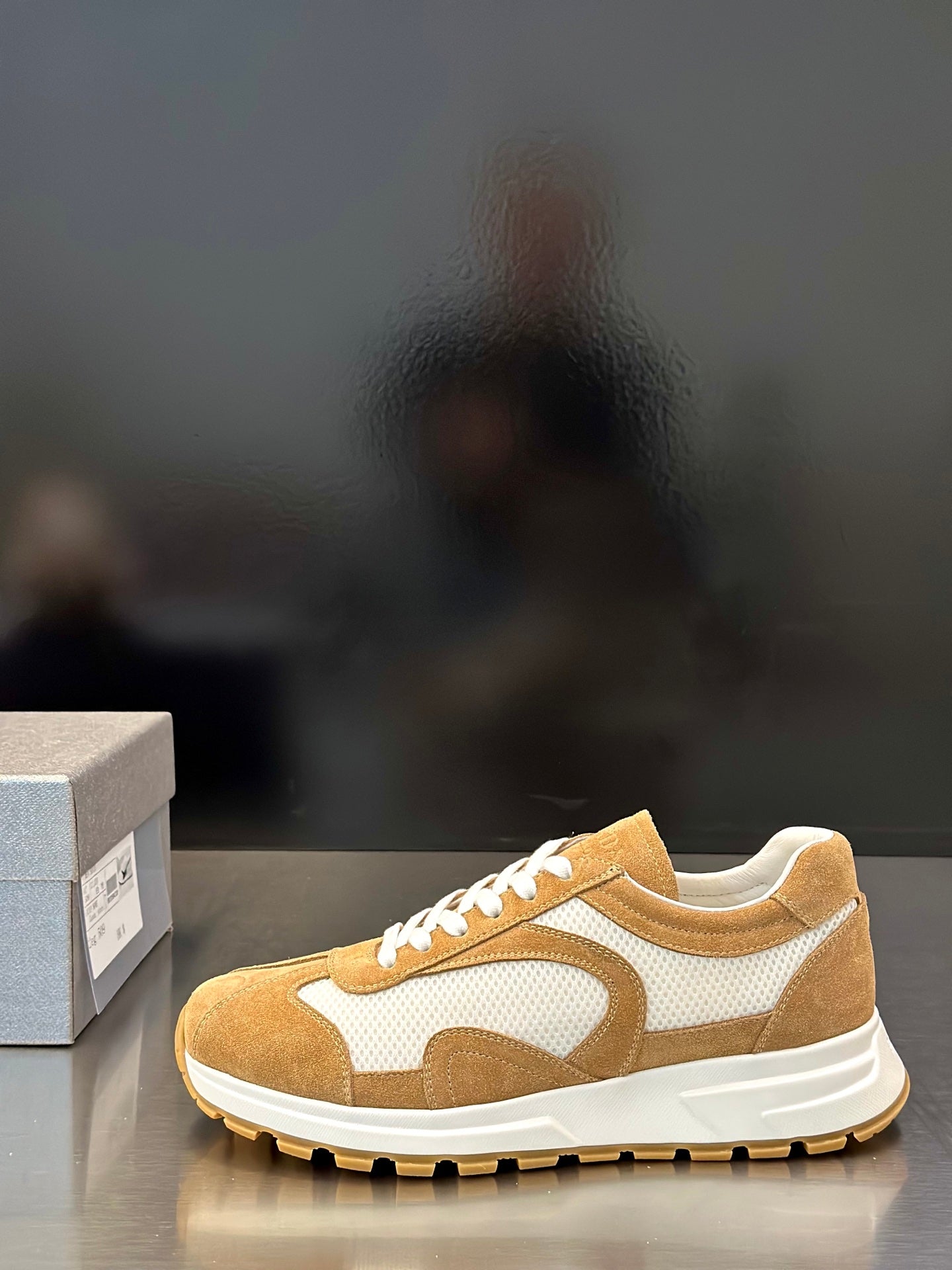 Tan suede low-top sneakers with white panel detailing and lace-up front