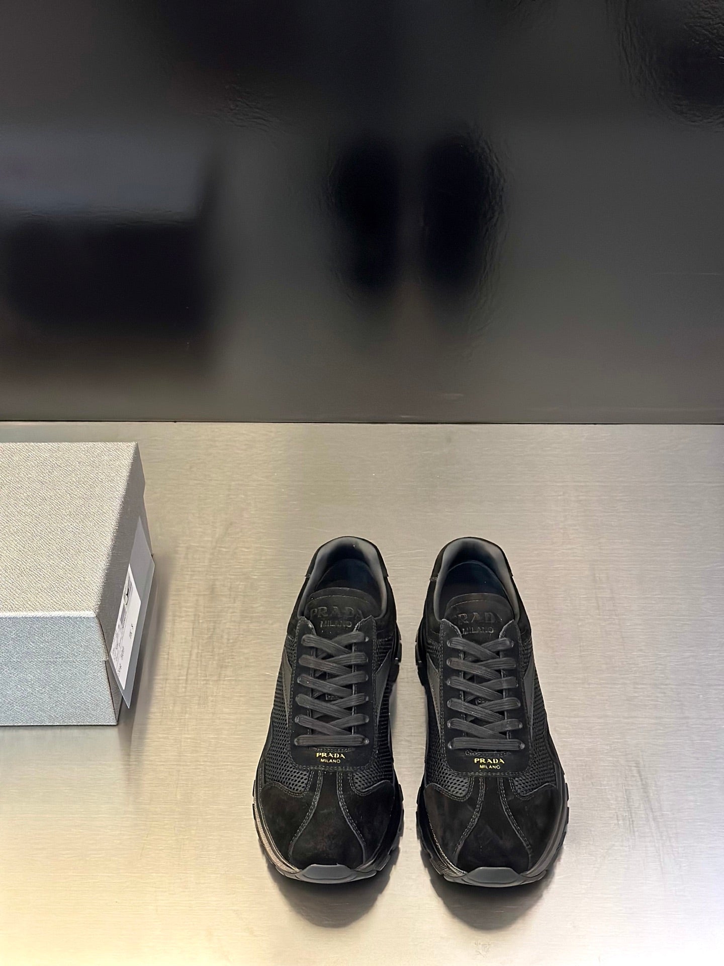 Prada unisex black sneakers with lace-up front and rubber sole