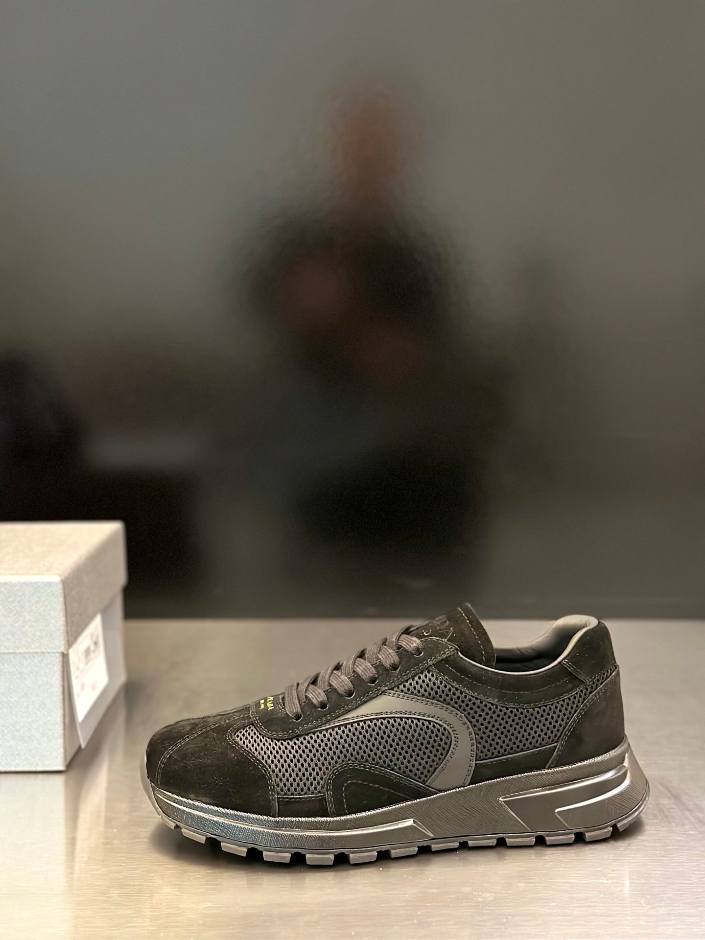Prada unisex sneaker with mesh upper, suede overlays, and lace-up closure