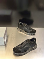 Prada unisex dark lace-up sneakers with textured panels and treaded outsole