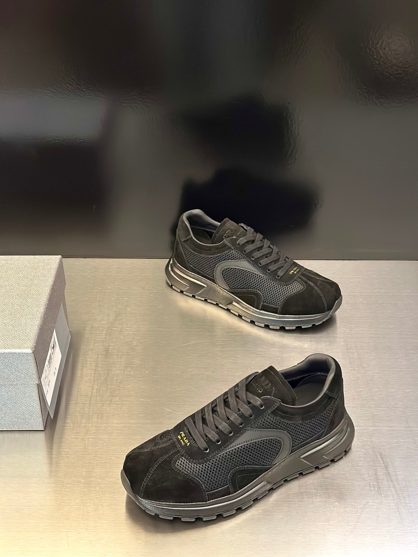Prada unisex dark lace-up sneakers with textured panels and treaded outsole