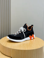 Hermes unisex sneakers, black upper with orange heel tab and white laces, white ribbed sole