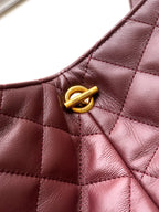 YSL quilted tote handle detail with gold hardware snap, burgundy leather