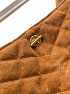 Tan quilted suede handbag with round gold snap and logo detail