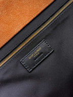 Saint Laurent leather label near zipper on black handbag lining
