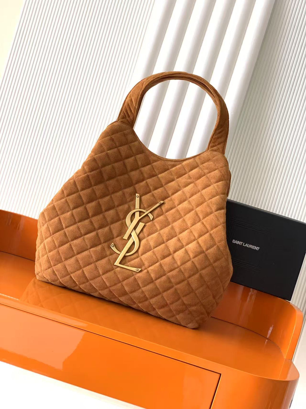 YSL quilted tote bag in tan suede with top handles and YSL logo pendant detail