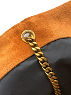 YSL bag zipper pull area with gold chain and round logo charm on tan suede