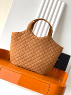 YSL quilted tote bag in tan suede with structured shape, top handles, and logo front