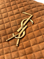 YSL logo metal emblem on tan quilted suede bag
