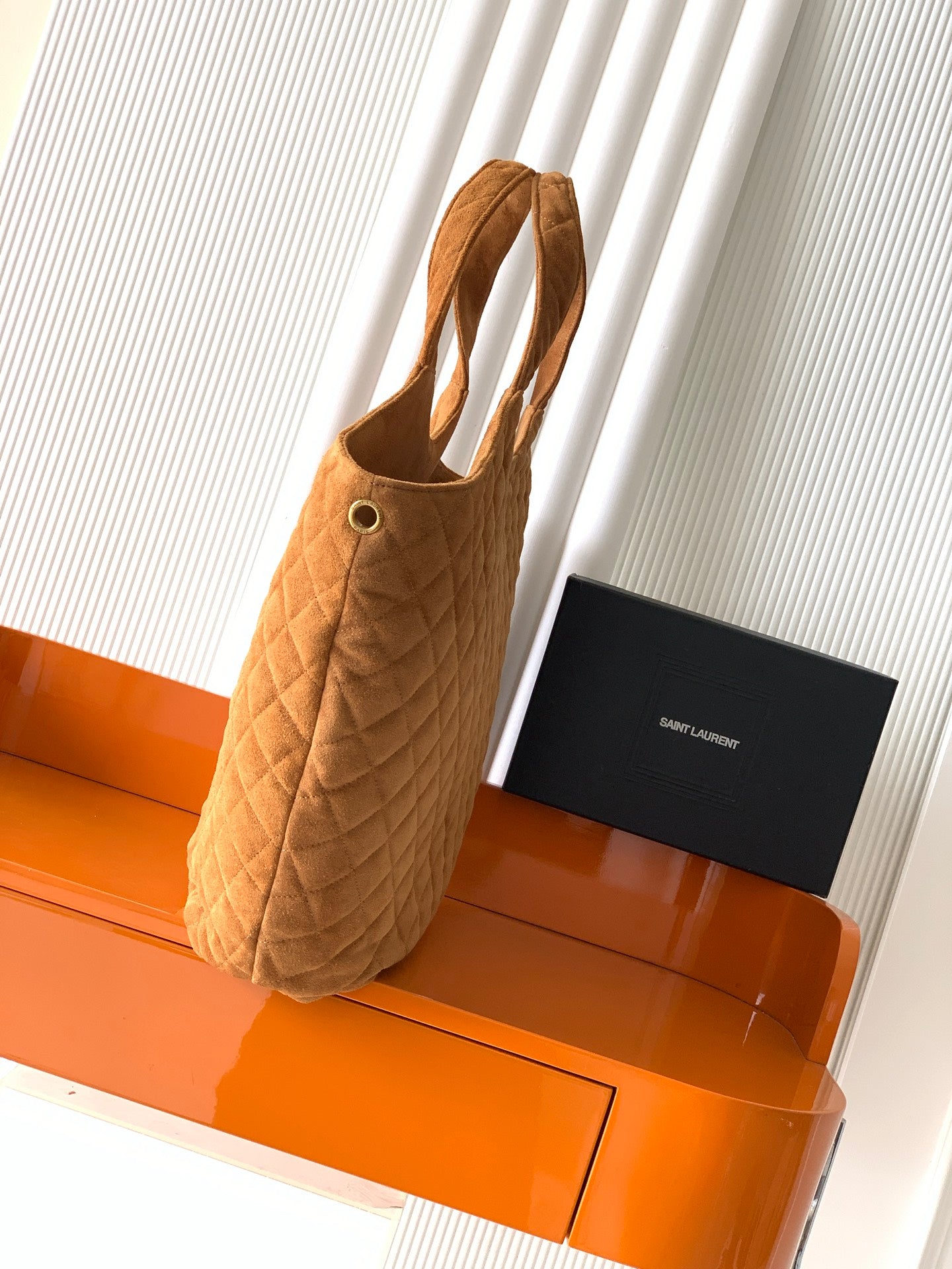 YSL quilted tote bag in tan suede, side view with handles and gold eyelet detail