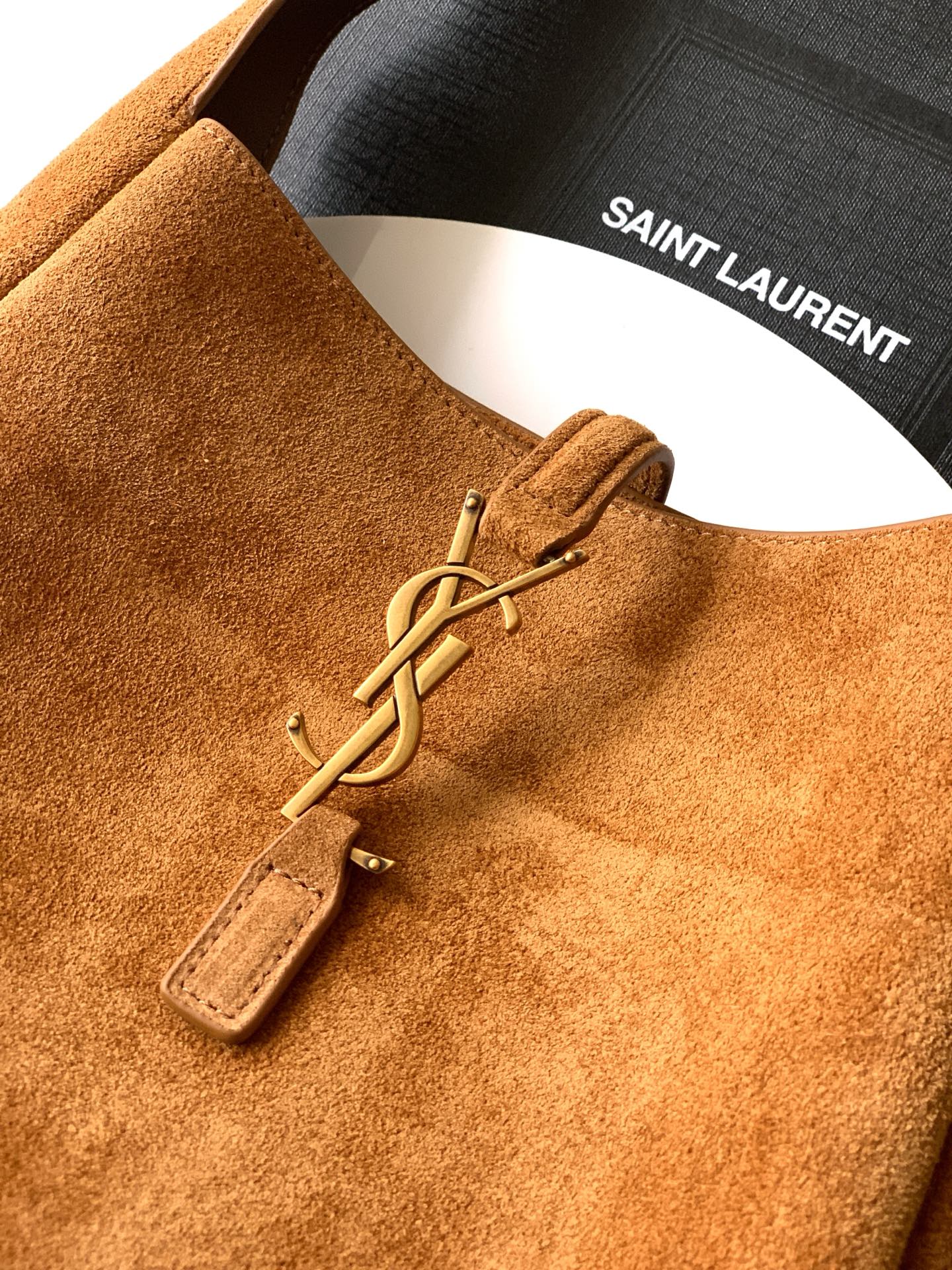 Tan suede bag with gold YSL zipper pull and SAINT LAURENT lining