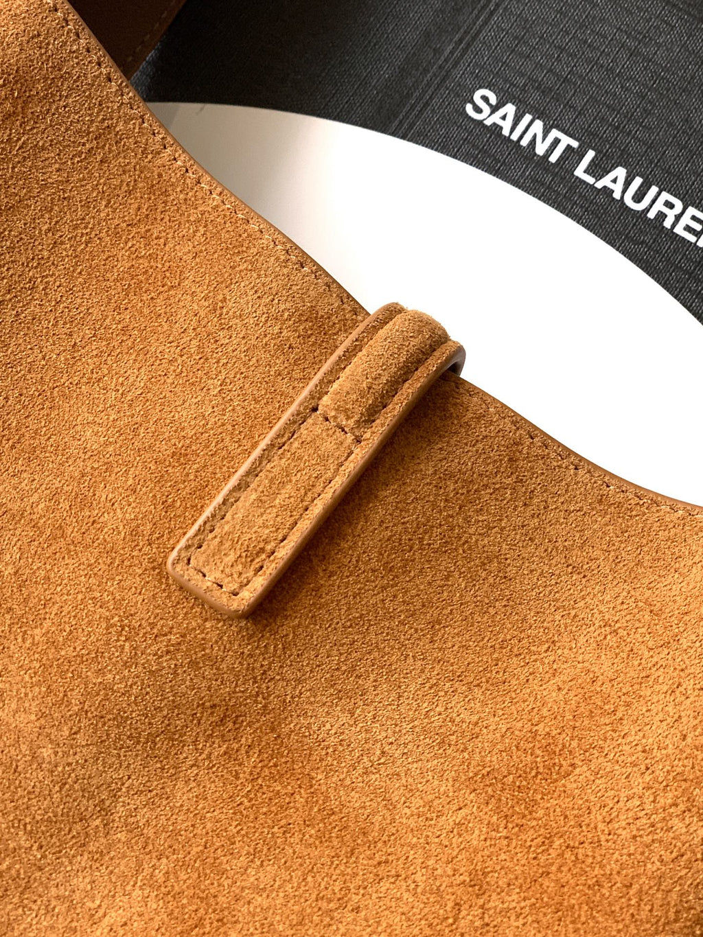 Tan suede strap with buckle tab and stitched edge