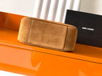 Tan suede shoulder bag with wide front panel and stitched seam trim