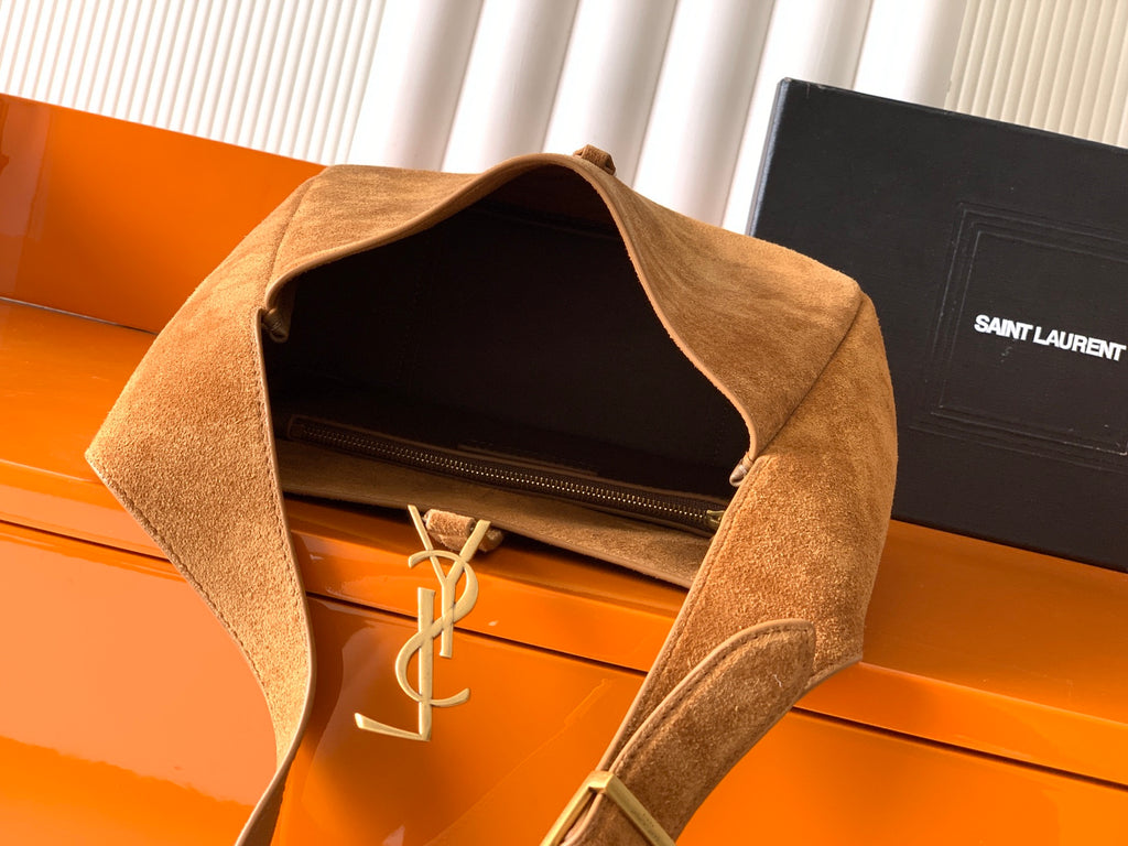 Open-top tan suede bag with zipper closure and hanging YSL charm