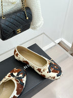 Cow-print ballet flats with cream laces on black shoebox set