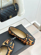 Leopard-print lace-up flats with black logo appliqué on a dark outsole.