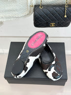 Chanel ladies flats, outsole view with pink CHANEL logo on dark sole
