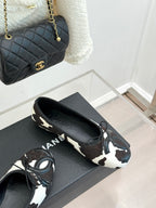 Chanel ladies flats, cow print with metal ring hardware and black heel tab