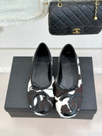 Chanel ladies flats, pair view with brown/black cow print and metal ring trim