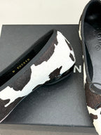 Chanel ladies flats close-up, black/white cow print upper with lace-up bow