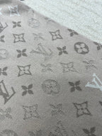 Louis Vuitton monogram T-shirt fabric close-up, light beige patterned knit
