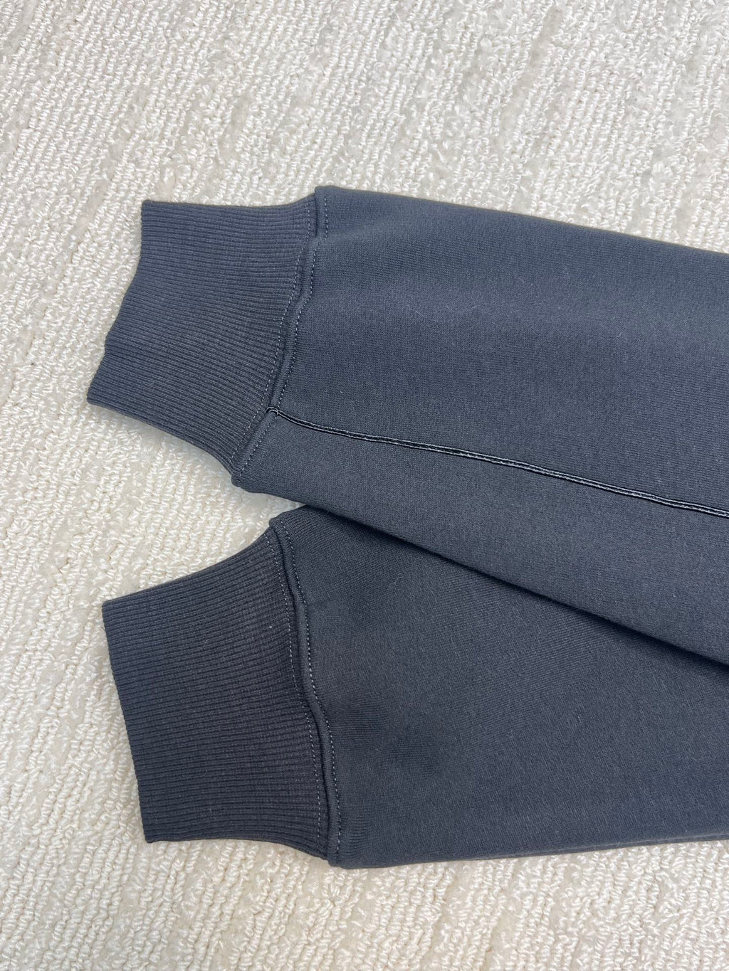 Dior hoodie sleeve cuffs and hem in dark navy knit fabric, folded view